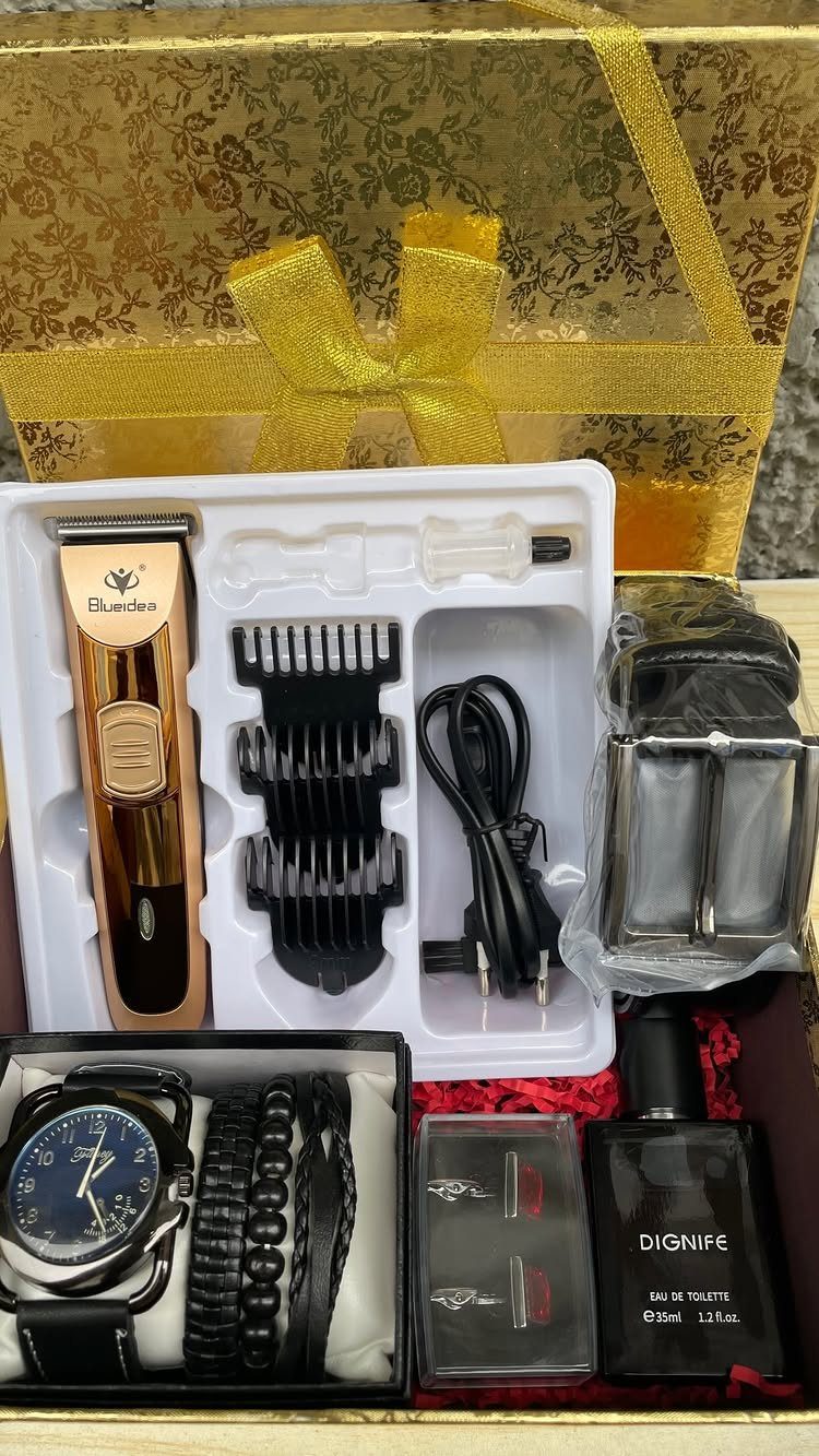 Grooming kit with gold hair trimmer, watch, bracelets, and fragrance in gold box.