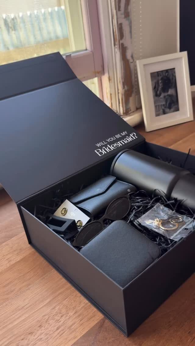 Black artisan gift box filled with a tumbler, sunglasses, and jewelry for a bridesmaid