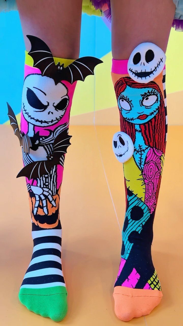 Knee-high Halloween socks featuring Jack Skellington and Sally with 3D bat attachments.