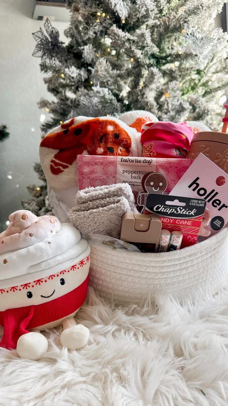 Festive gift basket with socks and treats next to a plush cocoa character.