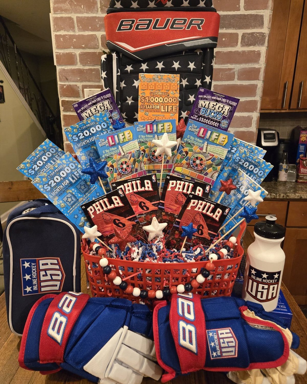 Lottery ticket gift basket surrounded by hockey gear and Philadelphia sports memorabilia.