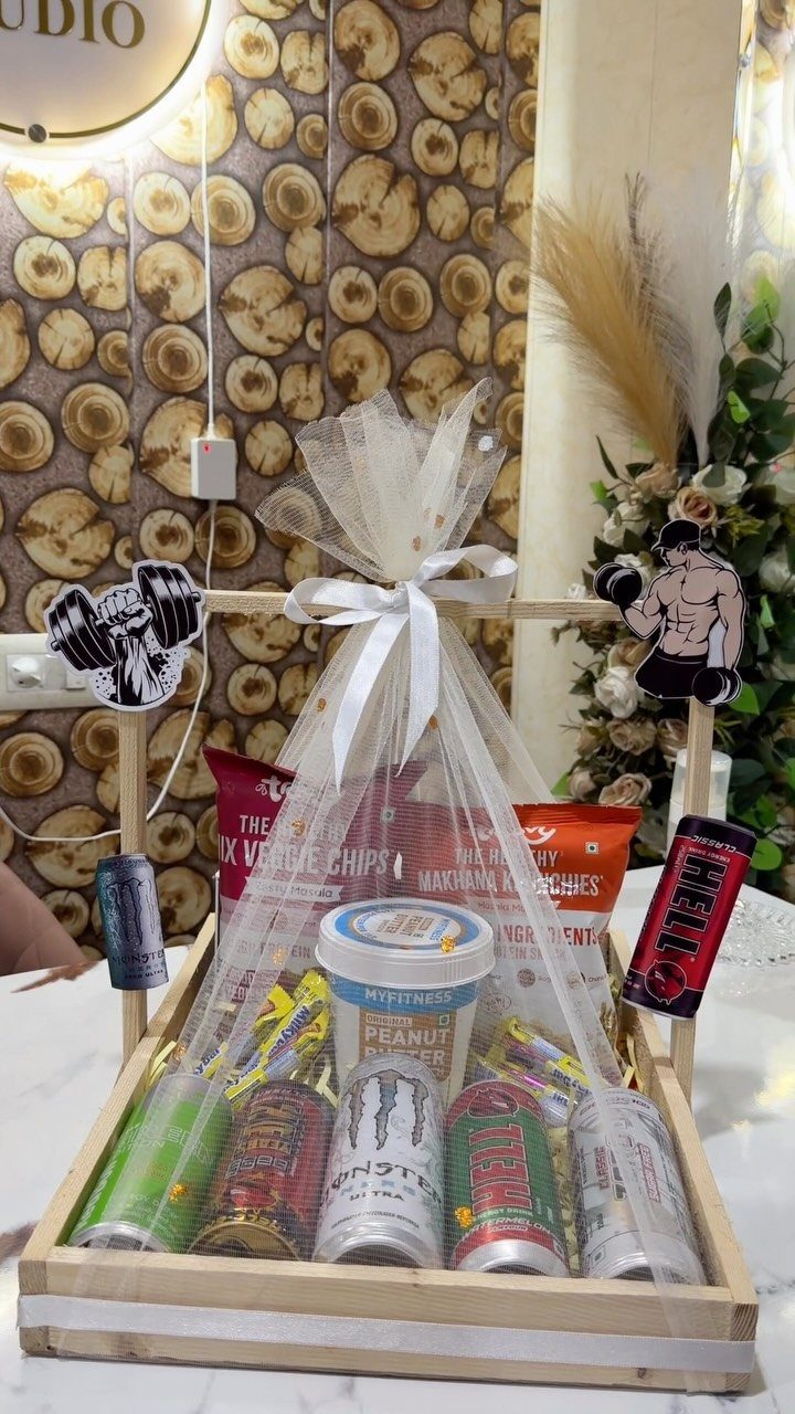 Wooden gift crate filled with snacks and drinks wrapped in white tulle bow