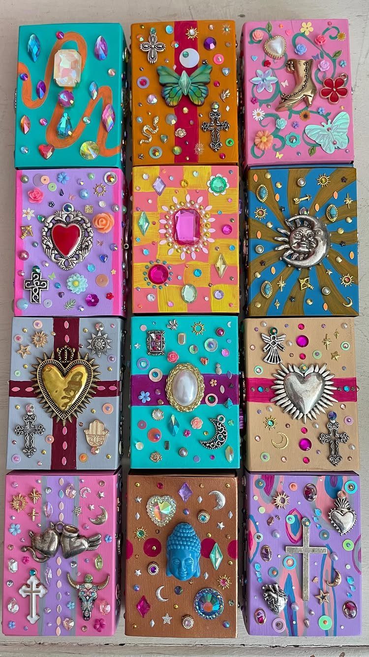 Twelve colorful decorated gift boxes with rhinestones, charms, and metallic heart ornaments.
