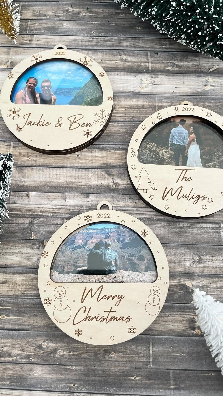 Three circular wooden photo ornaments with engraved names and dates on rustic wood.