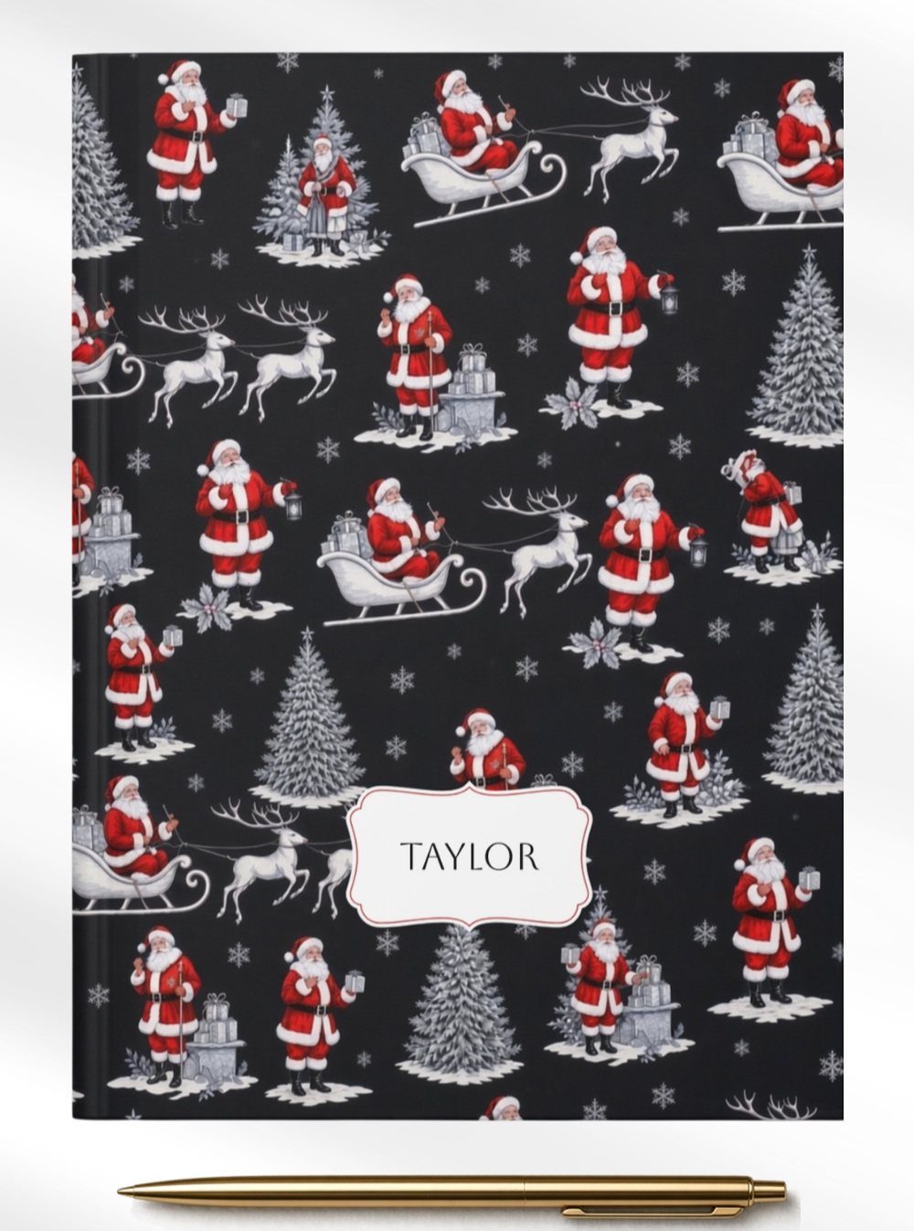 Personalized black Christmas journal with Santa pattern and a gold pen.