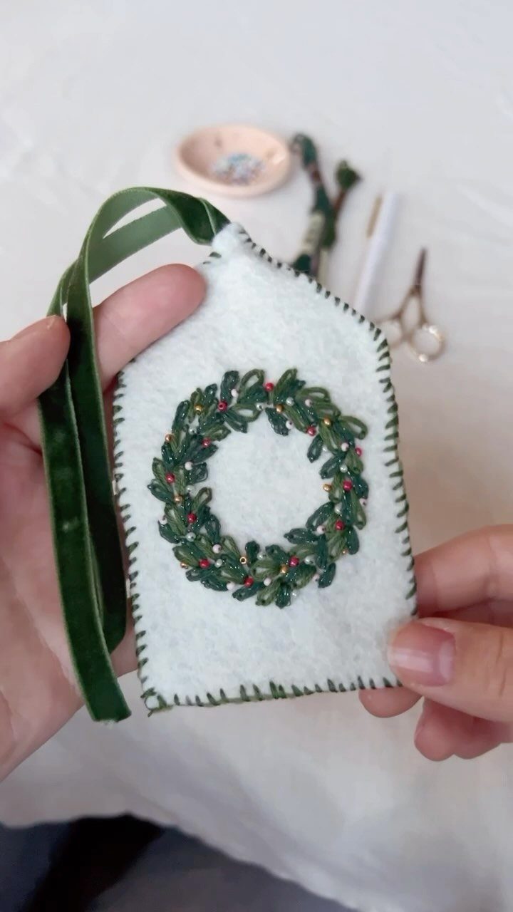 9 Christmas Gift Ribbon Ideas for Pretty Wrapped Presents 3 White felt gift tag with embroidered green wreath and dark green velvet ribbon.