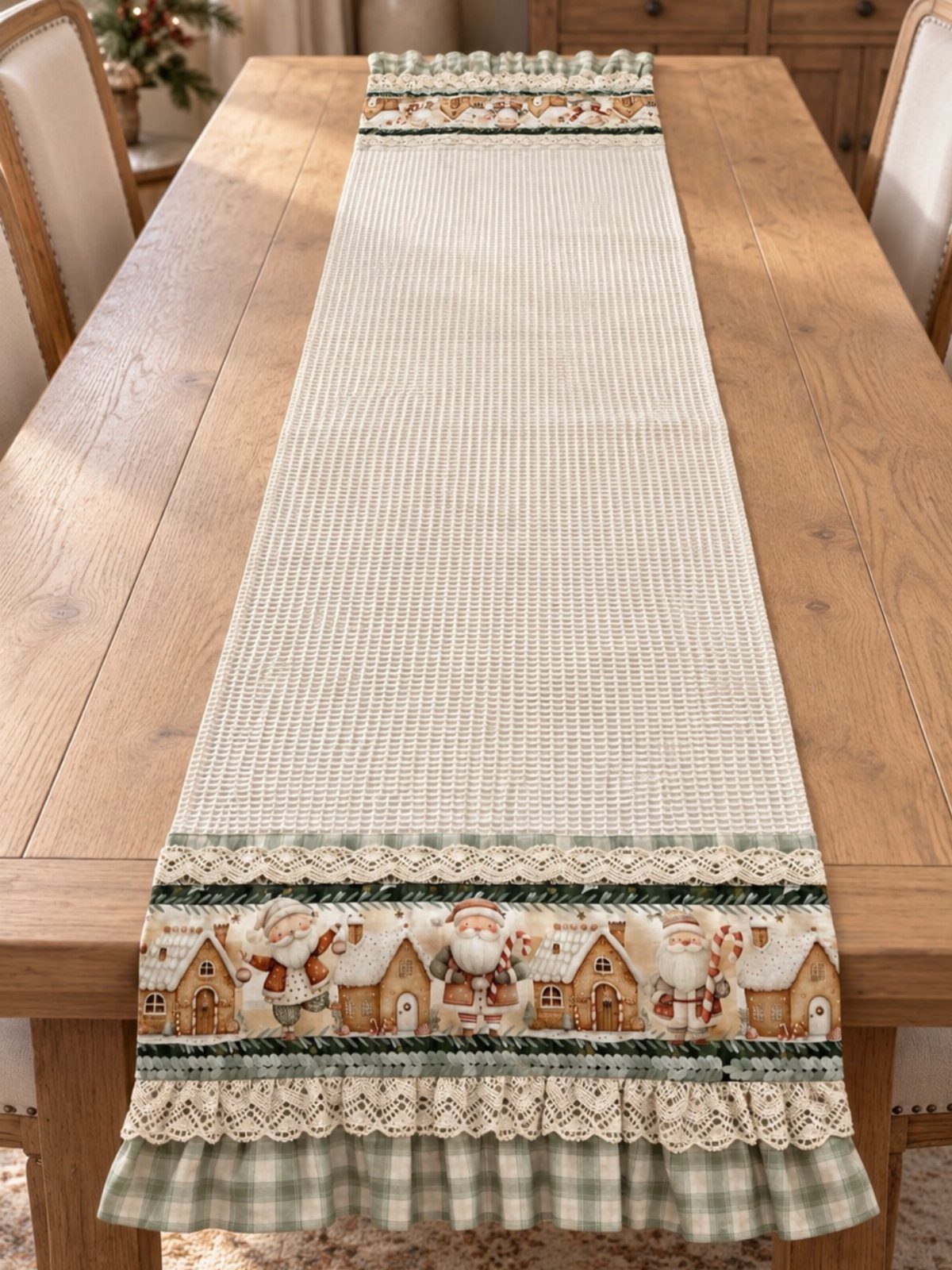 Cream textured table runner with Santa prints and green checkered ruffles on wooden table