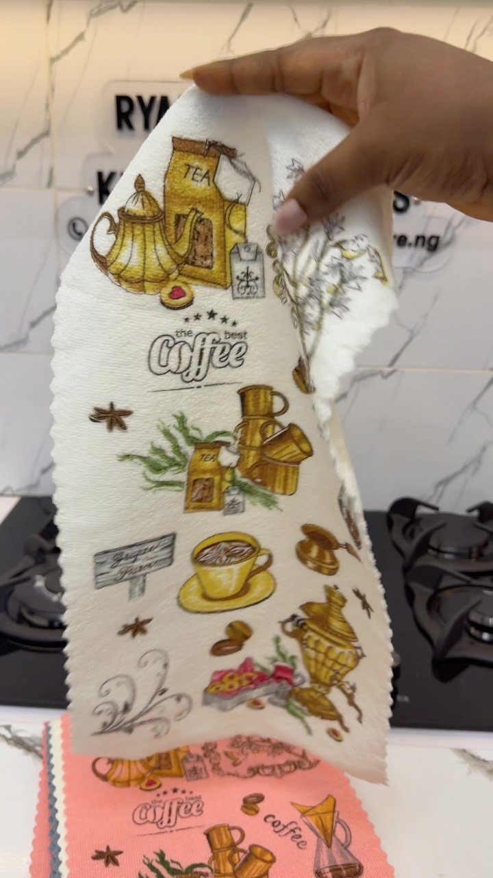 15 Coffee Drinker Gifts: Candles, Mugs, Roasters and More 7 White kitchen towel with vintage coffee illustrations held up in a kitchen setting.