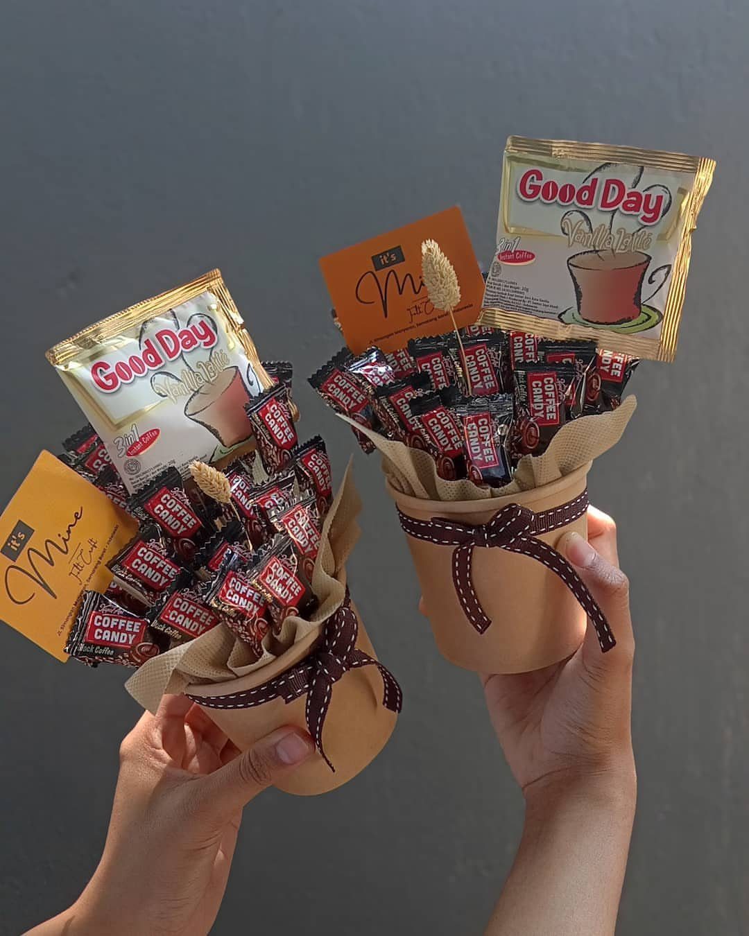 Two small brown buckets filled with coffee candies and instant coffee sachets.