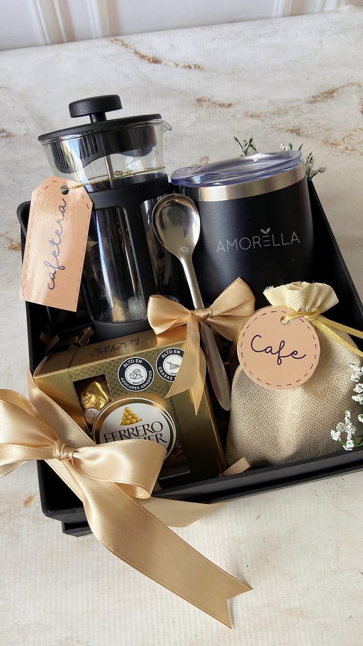 Coffee gift basket with French press, insulated tumbler, chocolates, and burlap coffee bag.