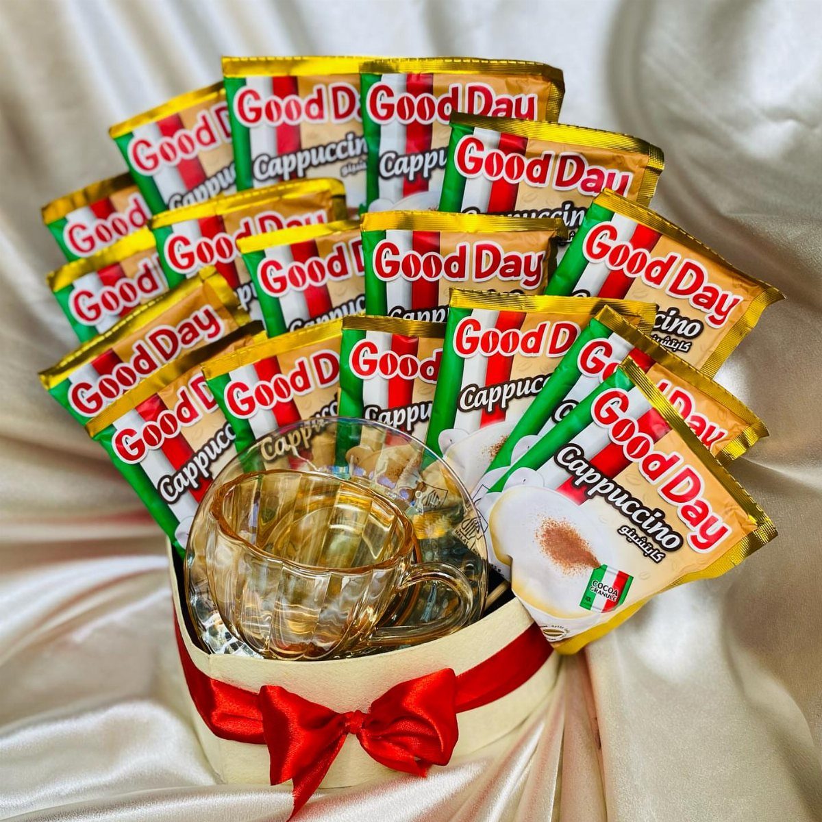 Coffee themed gift basket with instant coffee packets and a glass cup.