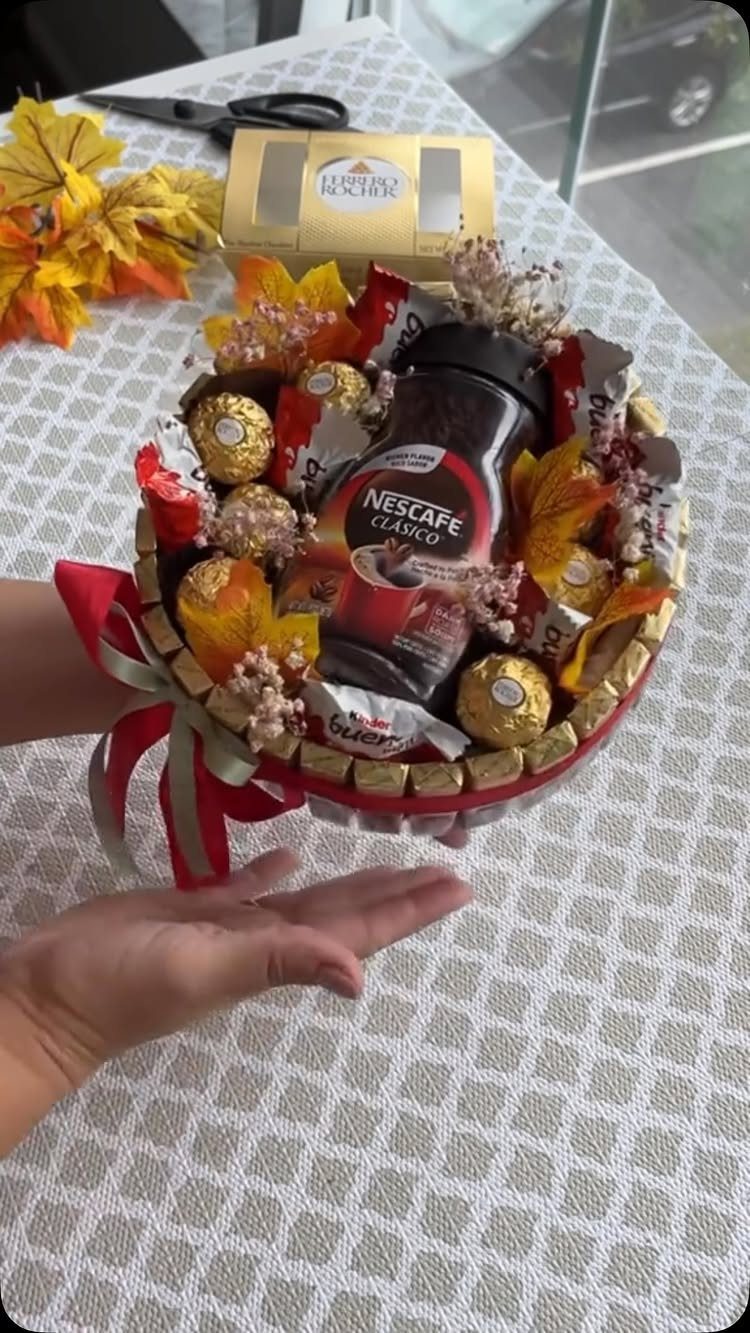 Coffee themed gift basket with Nescafe jar, gold chocolates, and autumn leaves.