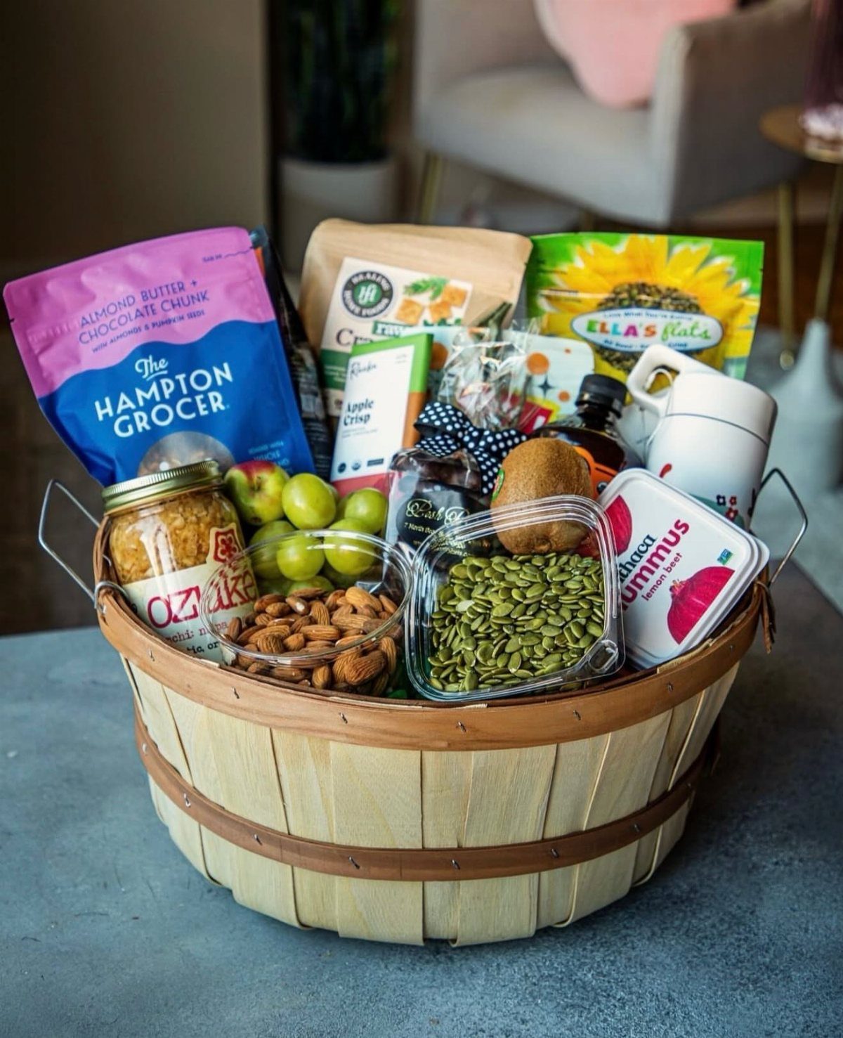 Comfort Gift Basket Ideas for Rough Days: 9 Picks 4 Wooden gift basket filled with snacks, fruits, nuts, and a white mug.