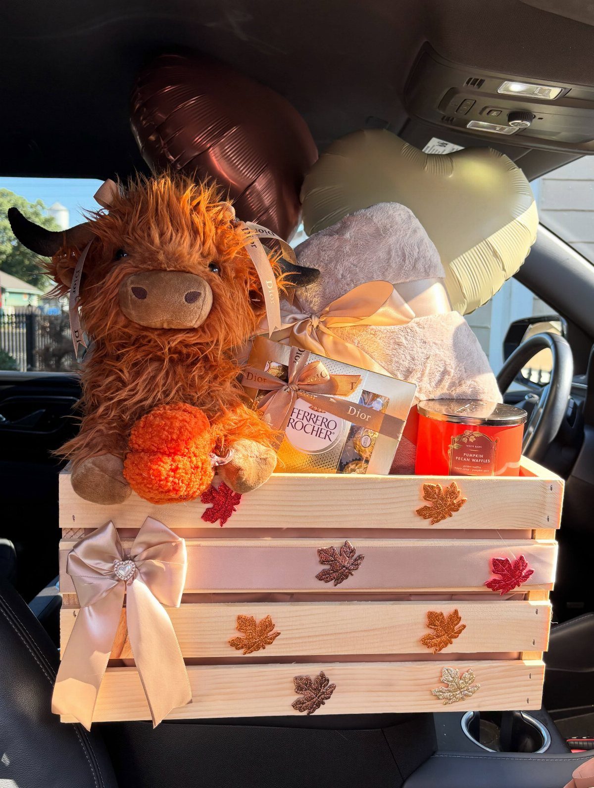 Comfort Gift Basket Ideas for Rough Days: 9 Picks 8 Comfort gift basket in a wooden crate with plush cow, chocolates, and candle.
