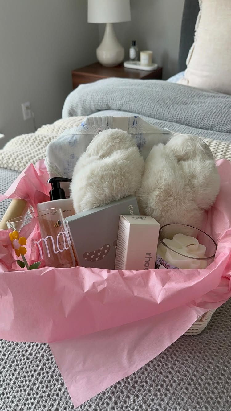 Comfort Gift Basket Ideas for Rough Days: 9 Picks 1 Gift basket with white fluffy slippers, lotion, and a candle on a bed.
