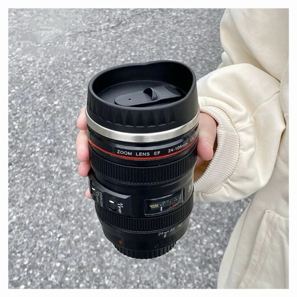 21 Cool Gifts for Adults: Practical Picks for 2026 10 Camera lens shaped travel mug held by a person in a white jacket.
