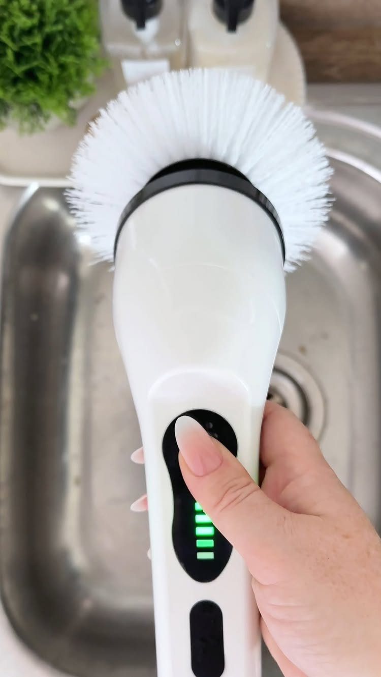 21 Cool Gifts for Adults: Practical Picks for 2026 1 White electric spin scrubber with a round brush held over a kitchen sink