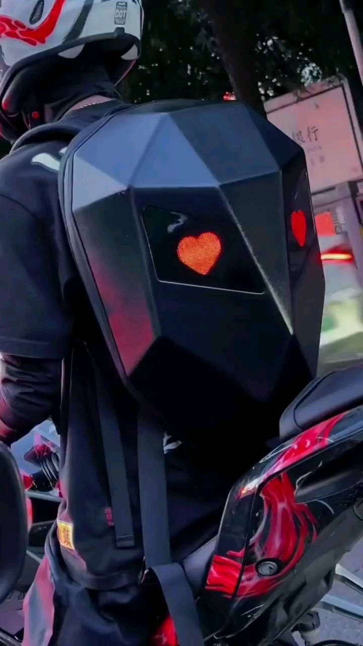 21 Cool Gifts for Adults: Practical Picks for 2026 12 Geometric black hard-shell backpack with glowing red heart on a motorcyclist