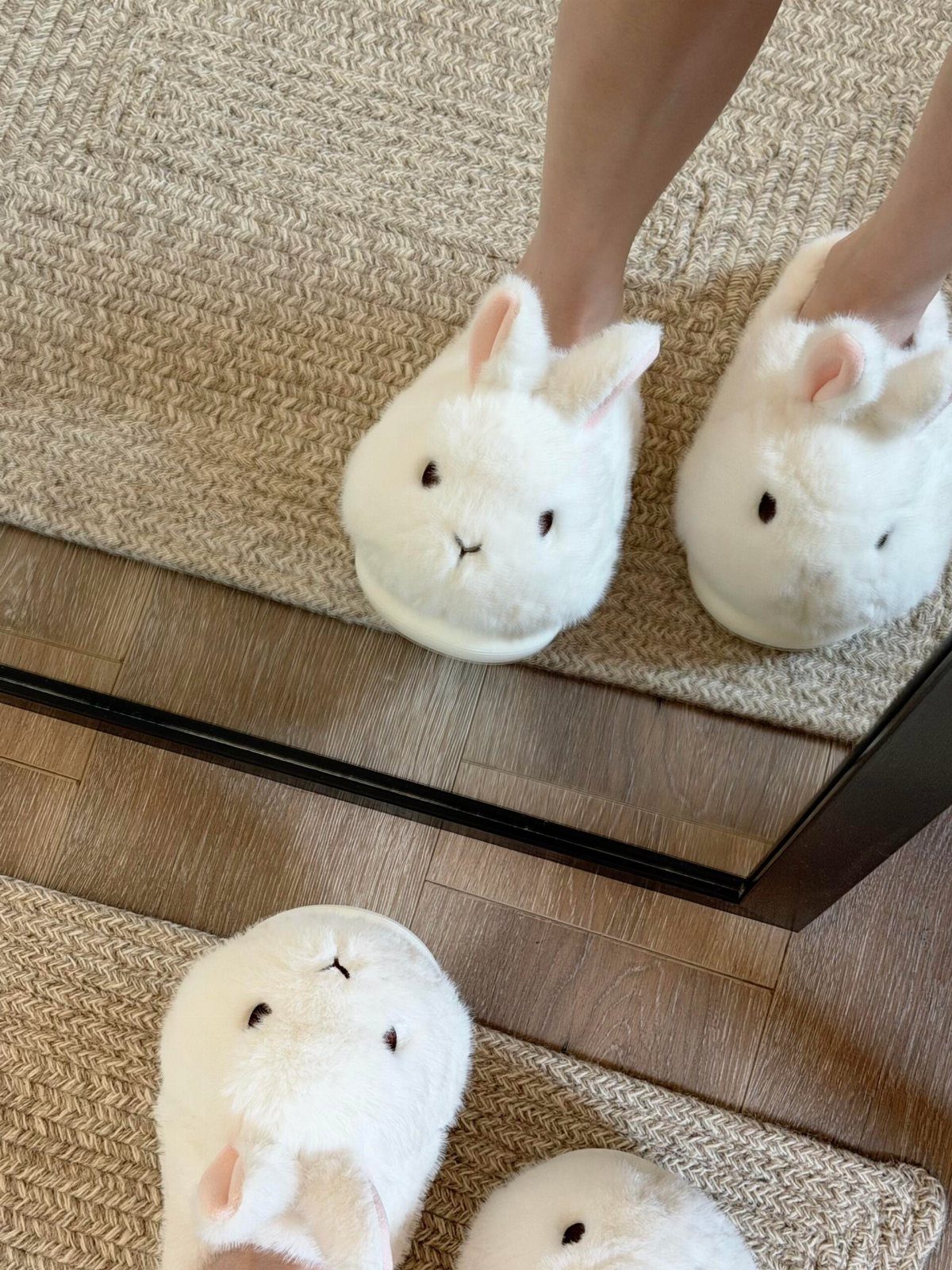21 Cool Gifts for Adults: Practical Picks for 2026 11 White bunny slippers on a person's feet reflected in a floor mirror.
