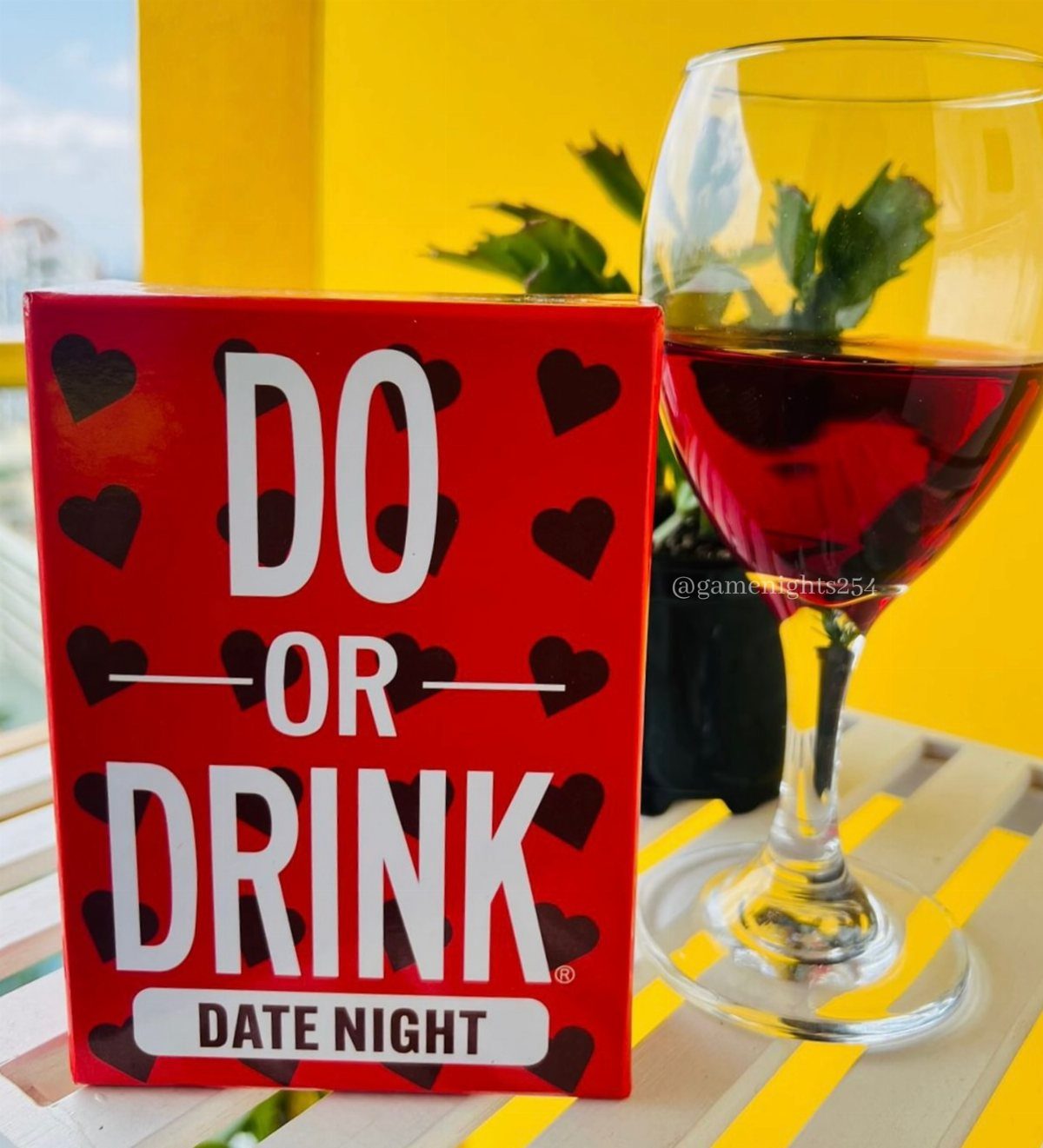Do or Drink Date Night game box next to a glass of red wine.