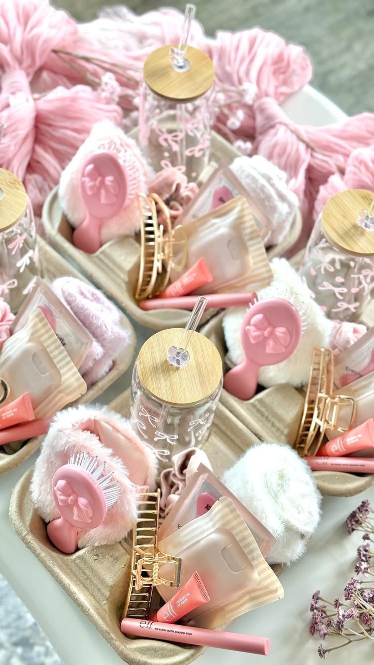 Spa kits with pink headbands, skincare products, and glass jars on beige trays.