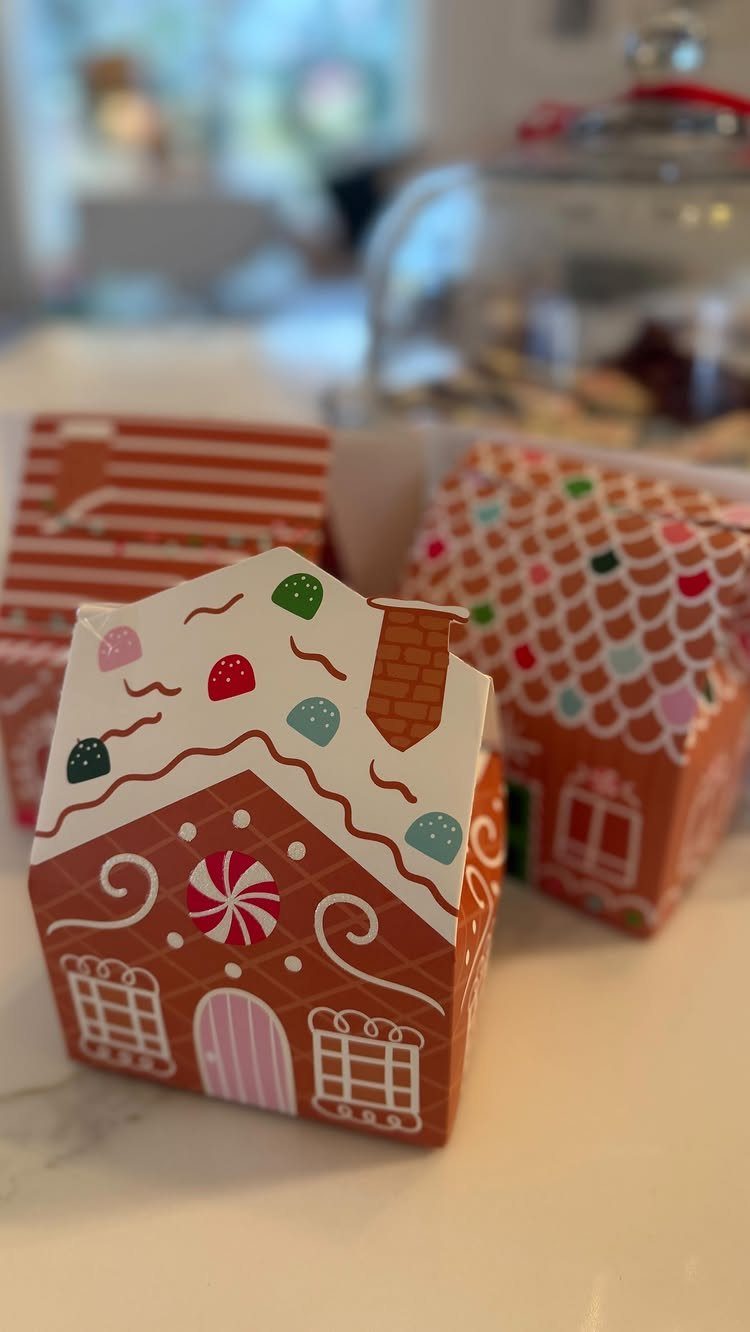13 Easy Gifts for Neighbors You Can Make or Bake 6 Gingerbread house shaped gift boxes with colorful candy decorations on white surface