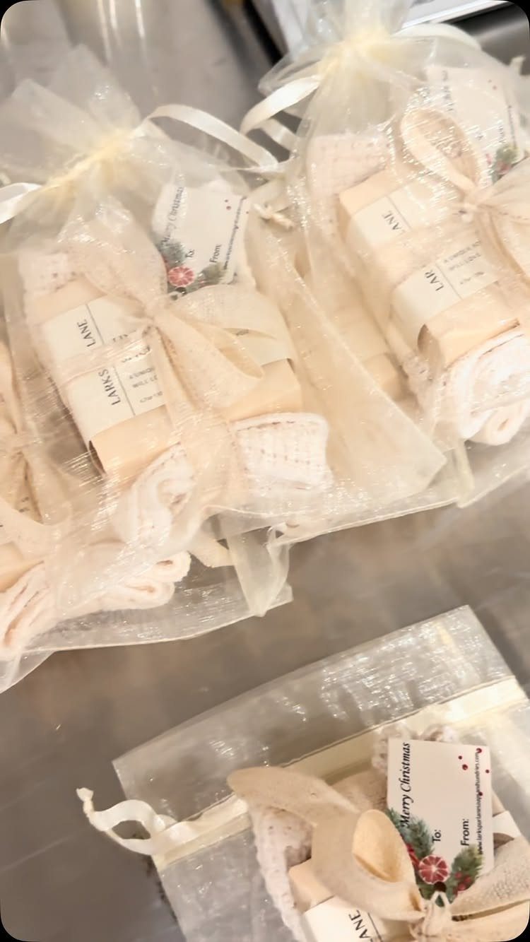 13 Easy Gifts for Neighbors You Can Make or Bake 3 Wrapped bars of handmade soap in sheer white organza gift bags with tags.