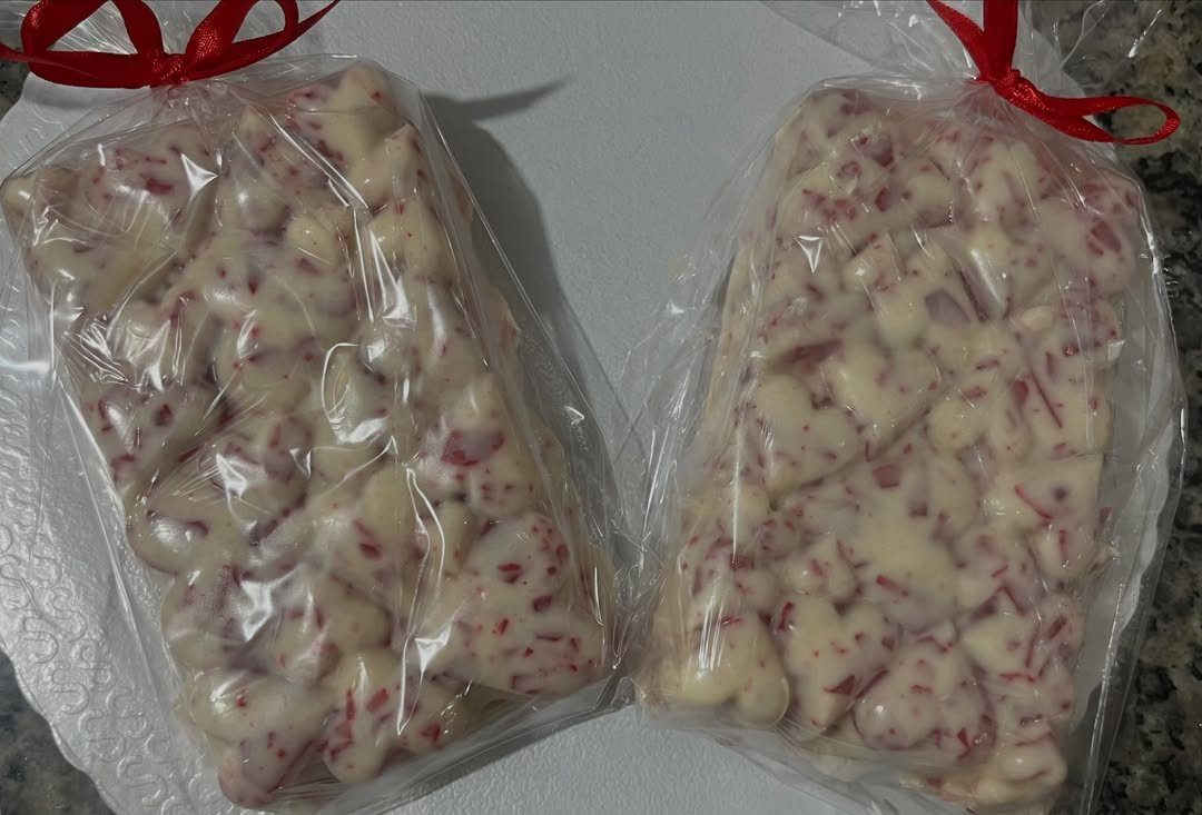 13 Easy Gifts for Neighbors You Can Make or Bake 13 White chocolate peppermint bark clusters in clear bags tied with red ribbons.