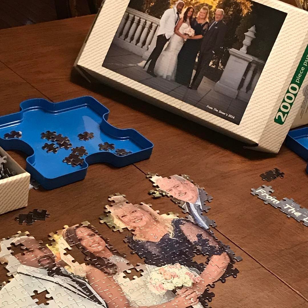 7 Father in Law Gift Ideas He'll Actually Use 7 Partially completed custom jigsaw puzzle of a wedding photo on a wooden table.