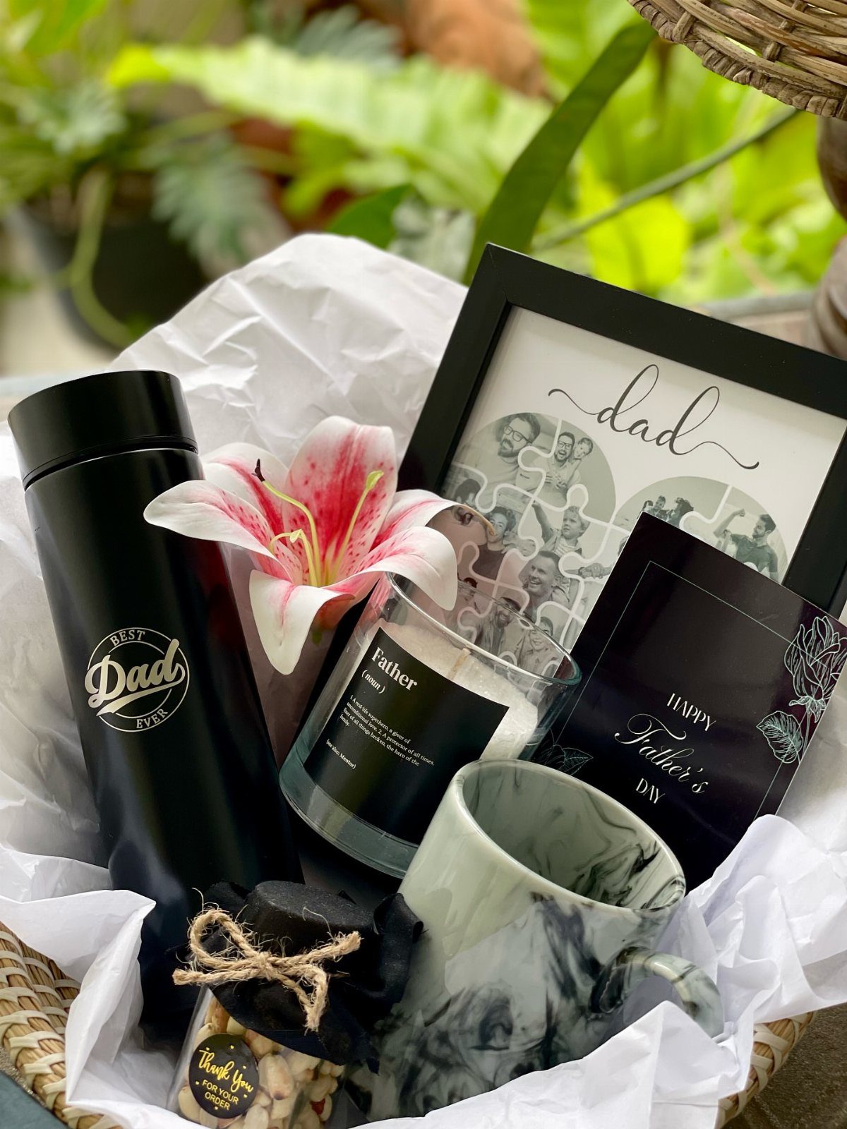 8 Fathers Day Gift Basket Ideas for Every Kind of Dad 7 Father's Day gift basket with thermos, framed puzzle, candle, mug, and pink lily.