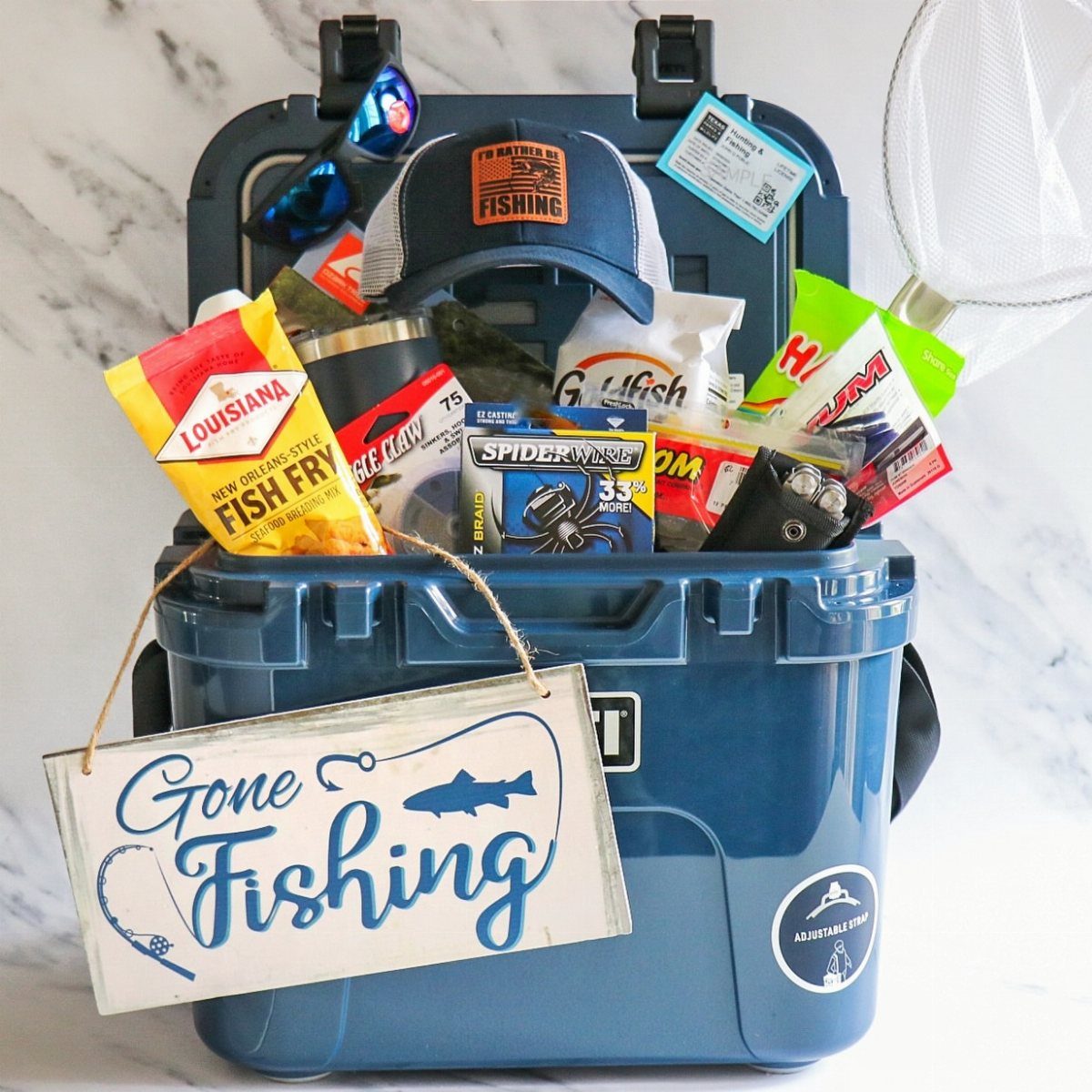 8 Fathers Day Gift Basket Ideas for Every Kind of Dad 4 Blue cooler gift basket filled with fishing gear and a Gone Fishing sign.
