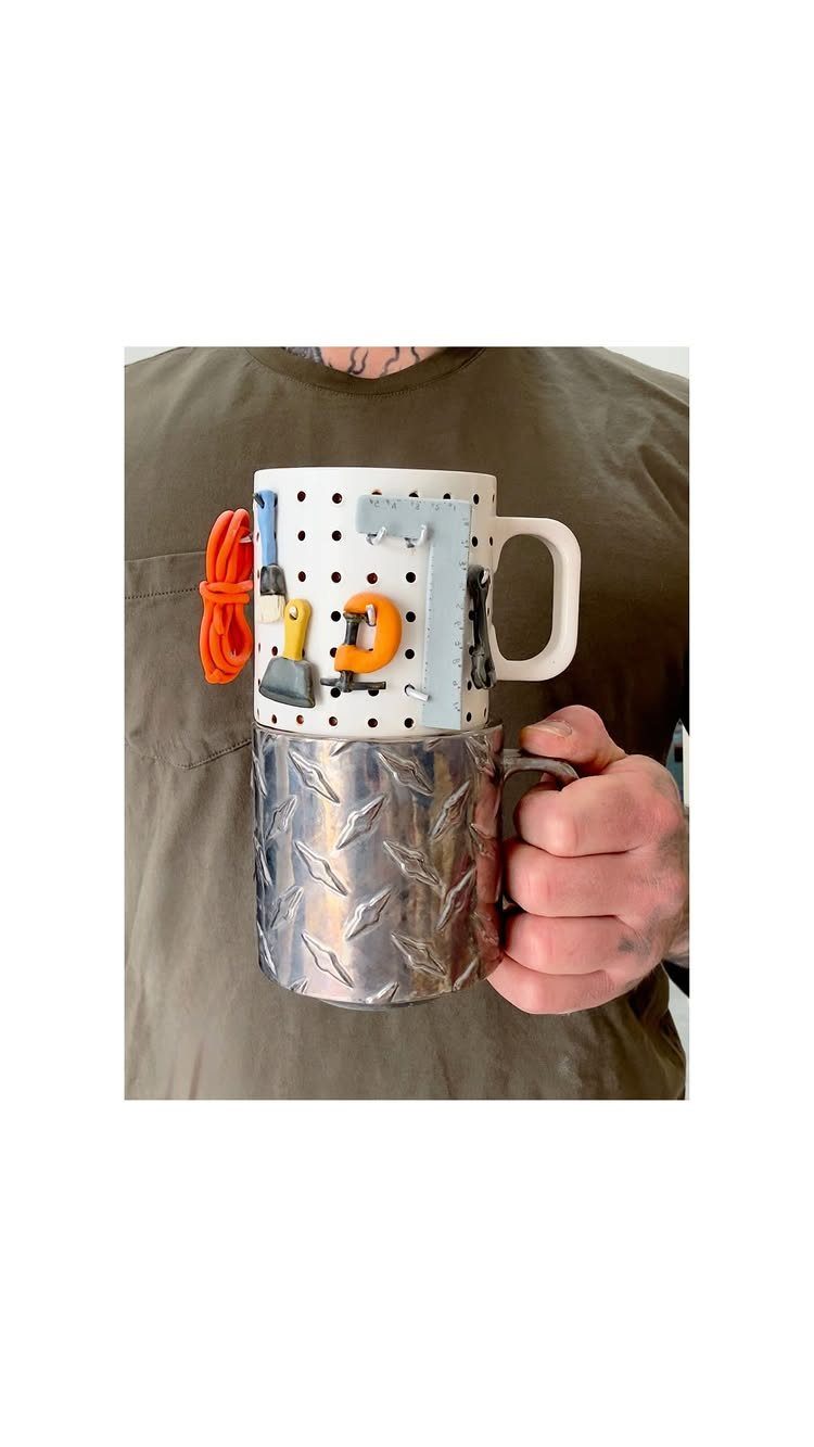 Two stacked mugs, one with a tool pegboard and one with diamond plate.