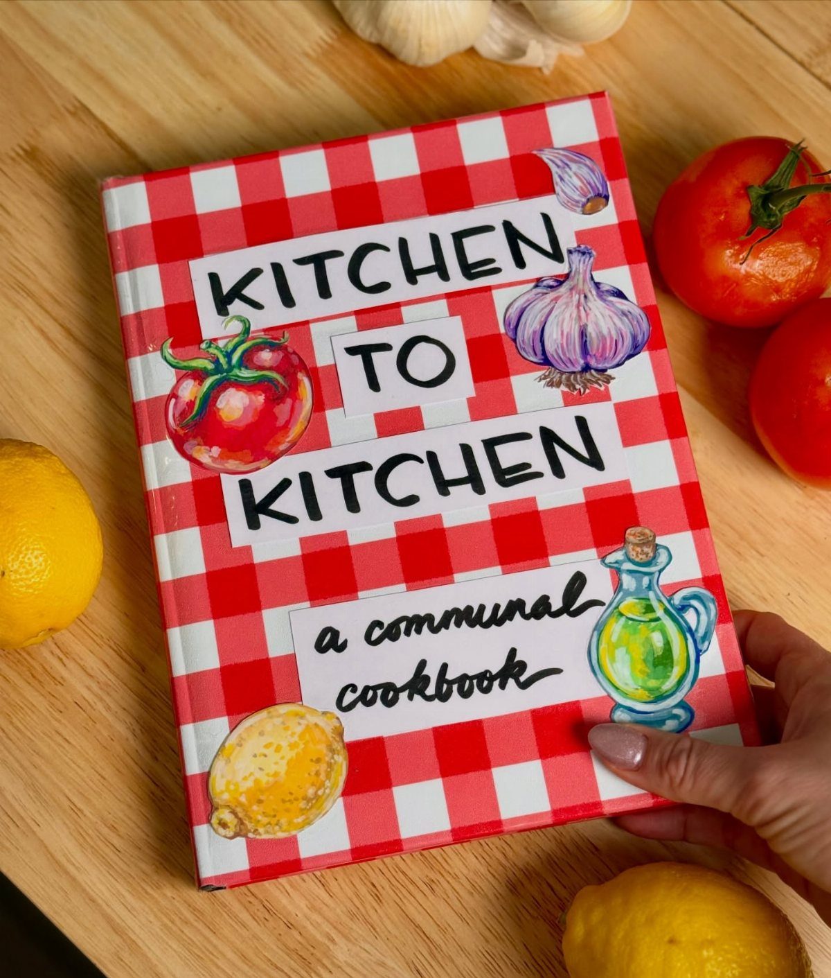 3 Free Gift Ideas With a Personal, Handmade Touch 1 Communal cookbook with red checkered cover surrounded by fresh vegetables on wooden table