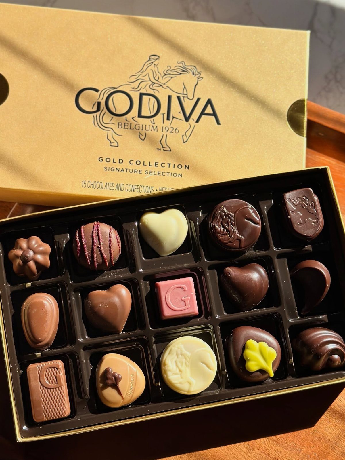 Assorted Godiva luxury chocolates in a gold signature collection gift box.