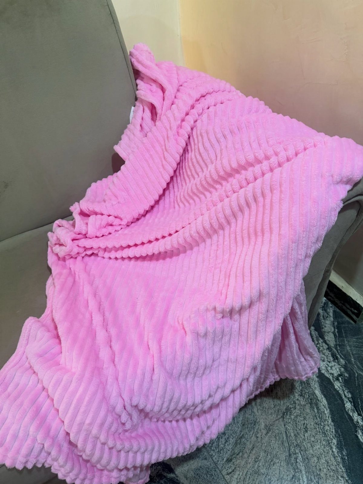 12 Gift Ideas for the Office Your Coworkers Will Use 9 Pink ribbed plush blanket draped over a grey office chair in a room