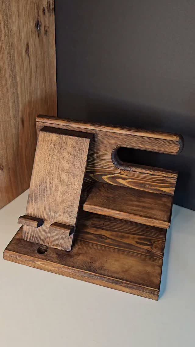 12 Gift Ideas for the Office Your Coworkers Will Use 5 Wooden desk organizer with a phone stand and tray on a white surface.