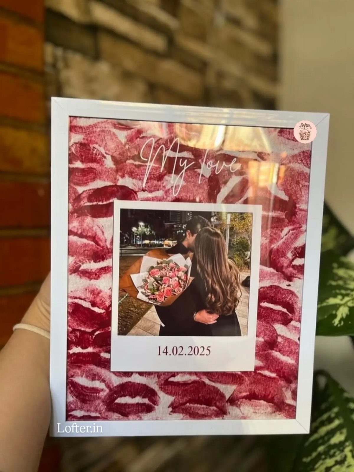 White framed photo of a couple with red lipstick kiss marks and text.