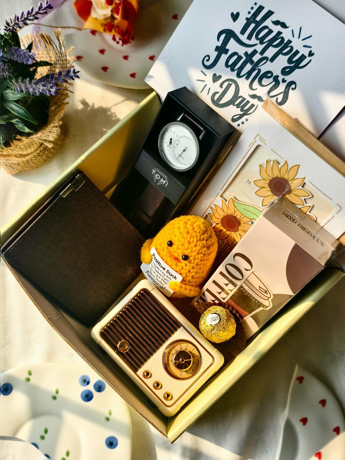 7 Gifts for Dad From Son That Feel Personal and Fun 7 Father's Day gift box with wallet, watch, miniature radio, and greeting card.