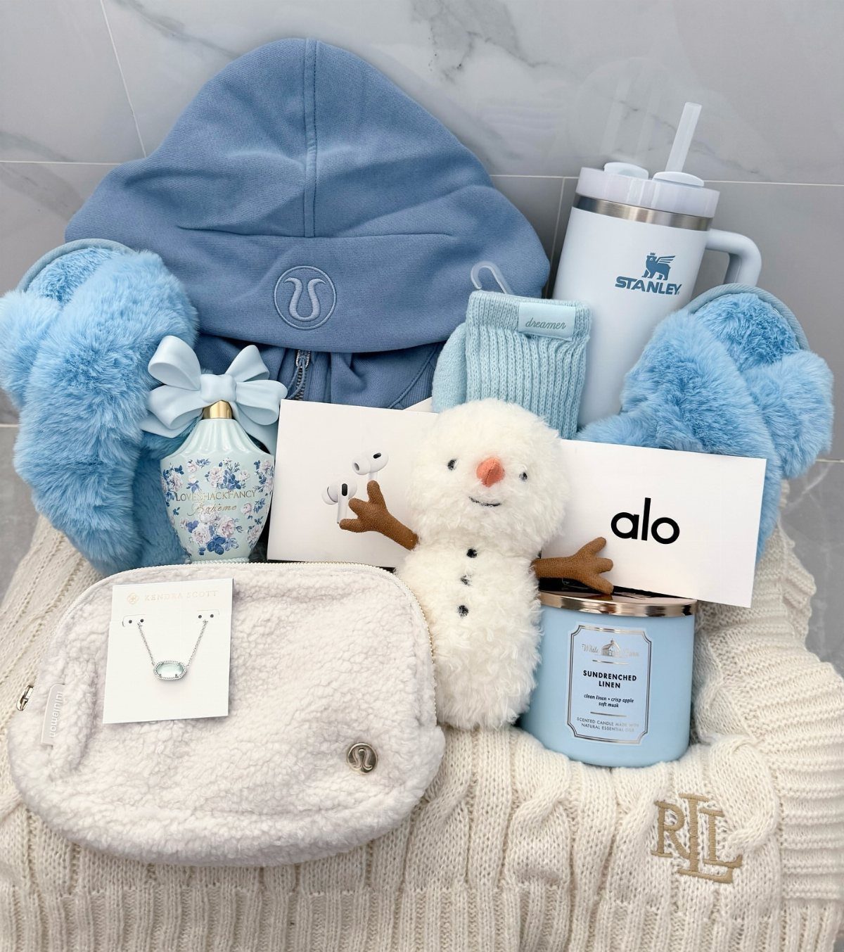 Blue and white gift set with a fuzzy belt bag and Stanley tumbler