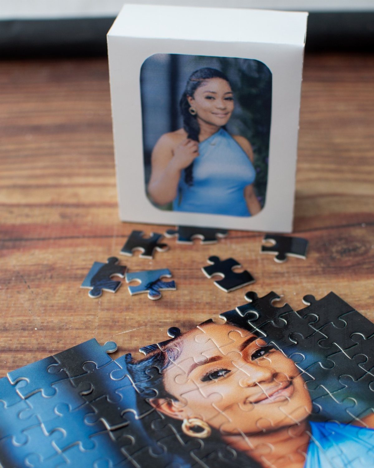 Custom jigsaw puzzle and box featuring a portrait of a woman on wood.