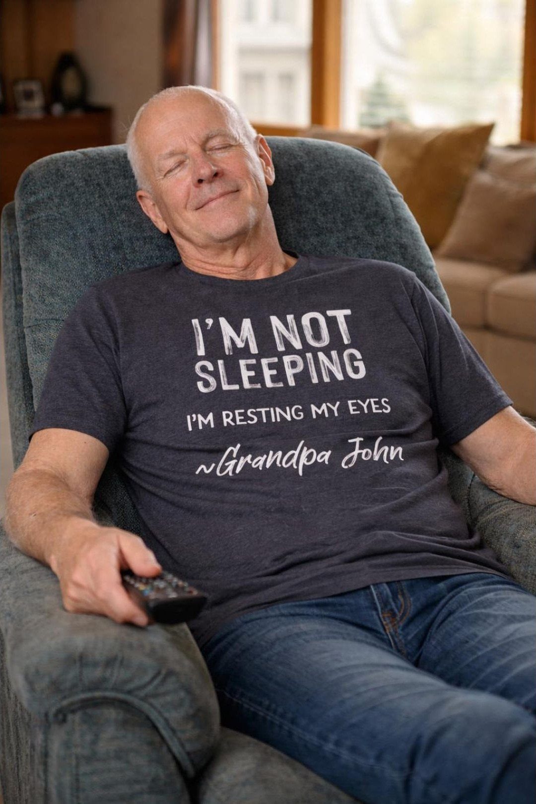 6 Gifts for Grandpa Who Has Everything: Personal Picks 2 Older man reclining in a chair wearing a personalized Grandpa John t-shirt.