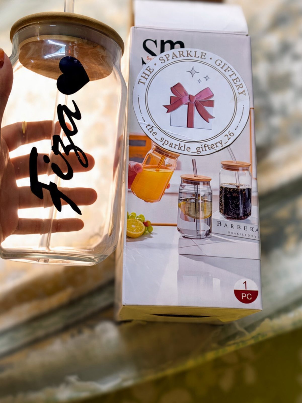 Personalized glass jar with name Fiza and wooden lid next to its packaging.