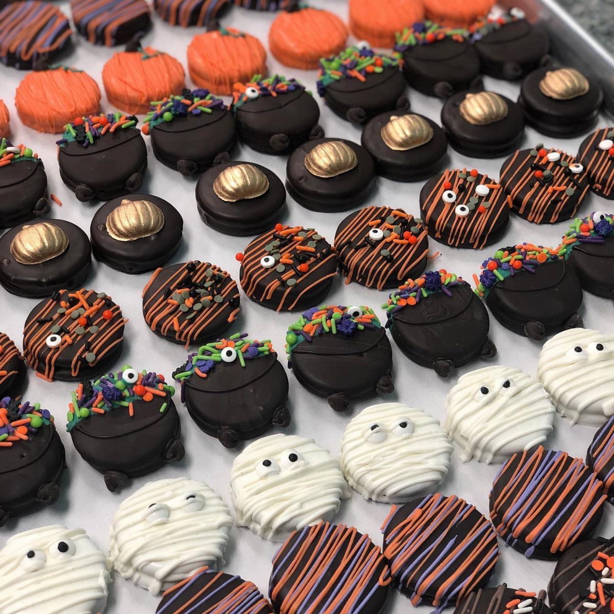 Halloween Food Gifts: 16 Sweet and Spooky Ideas 7 Chocolate-covered sandwich cookies decorated as ghosts and with orange and purple drizzles.