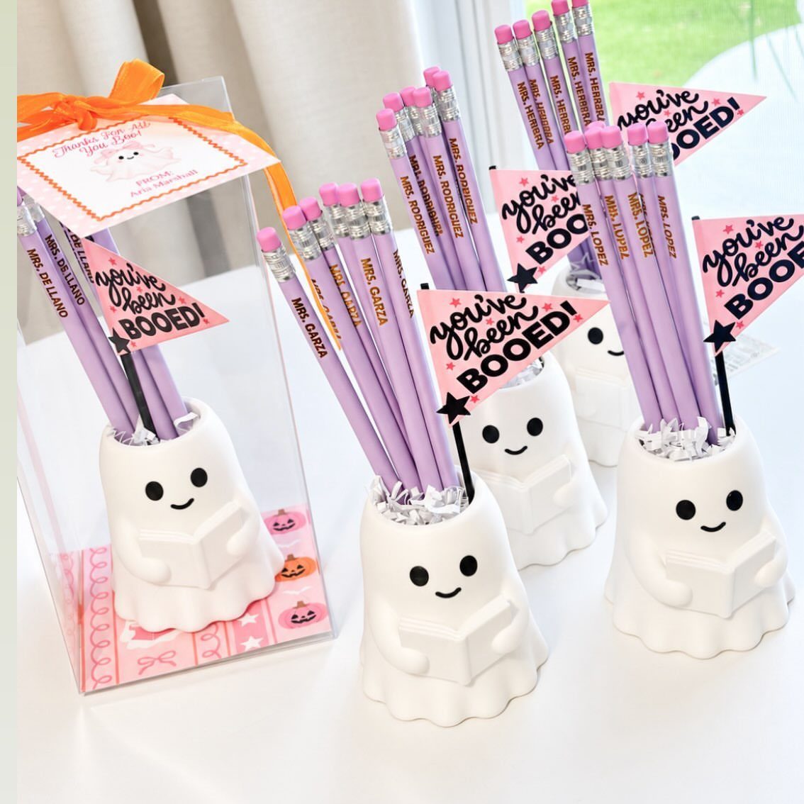 Halloween Teacher Gifts: 10 Ideas Teachers Will Like 10 Ghost-shaped pencil holders with purple pencils and 'you've been BOOED!' flags as gifts.