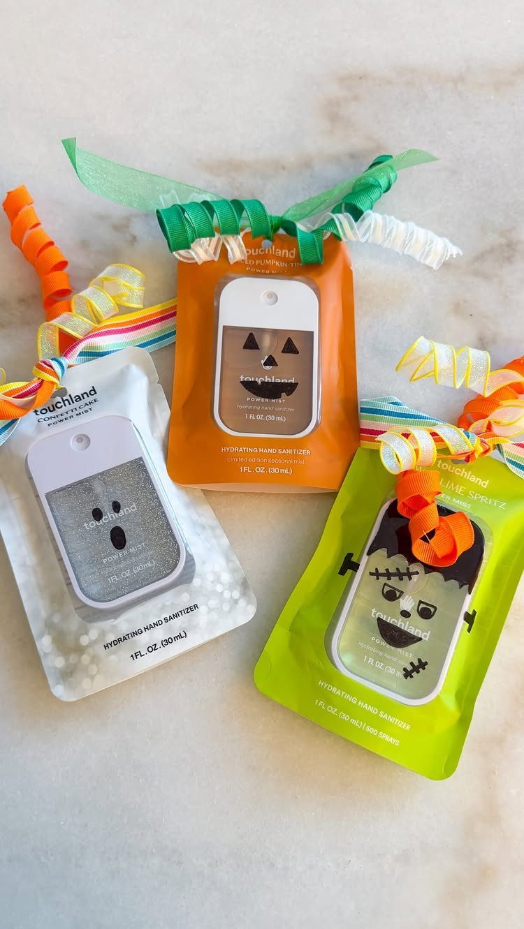 Halloween Teacher Gifts: 10 Ideas Teachers Will Like 7 Hand sanitizer bottles decorated as Halloween characters with colorful ribbons on marble.