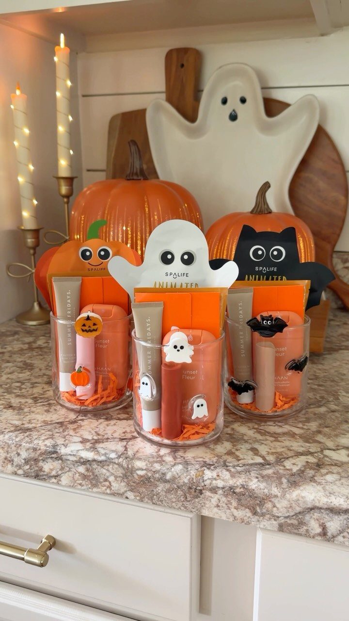 Halloween Teacher Gifts: 10 Ideas Teachers Will Like 8 Halloween gift sets in glass cups with lip balms and themed cards.