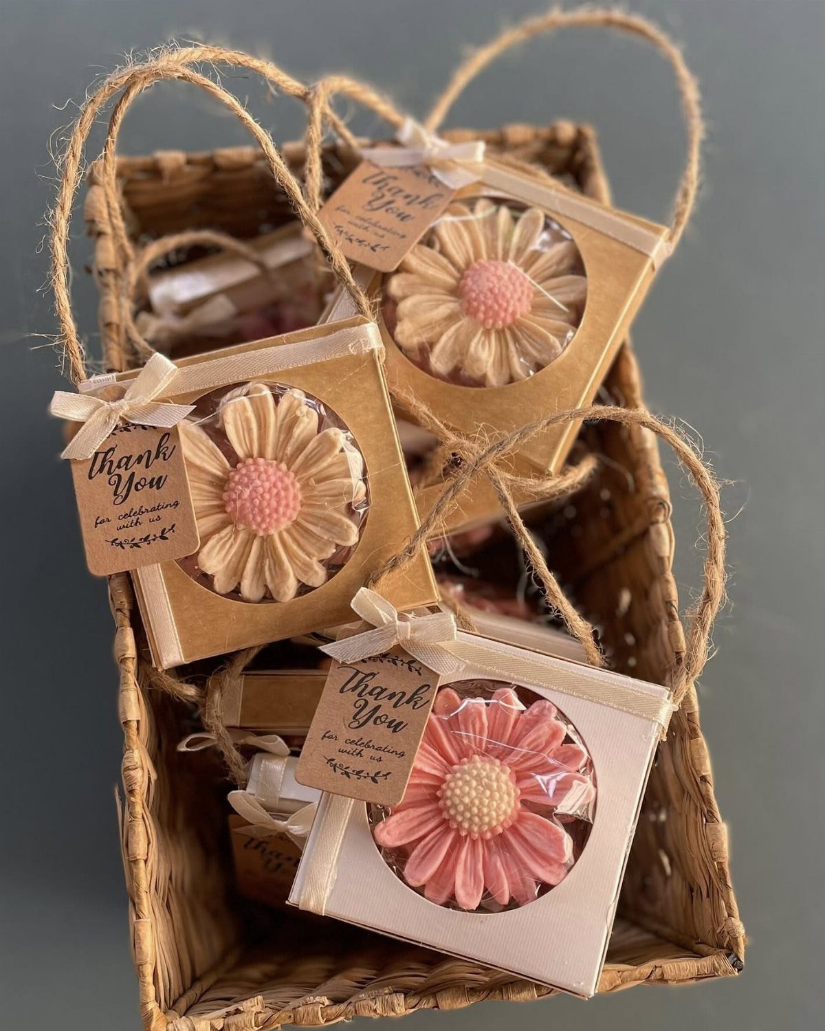 Flower-shaped soaps in gift packaging with thank you tags in a wicker basket