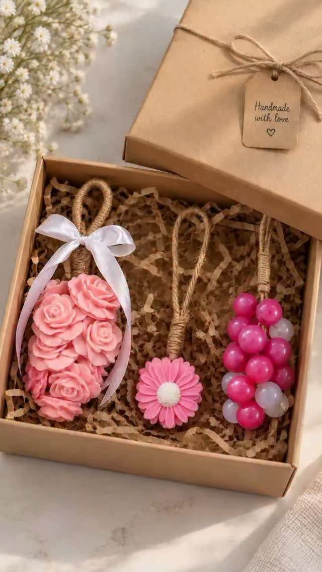 Pink decorative soaps in a kraft gift box with shredded paper filler.