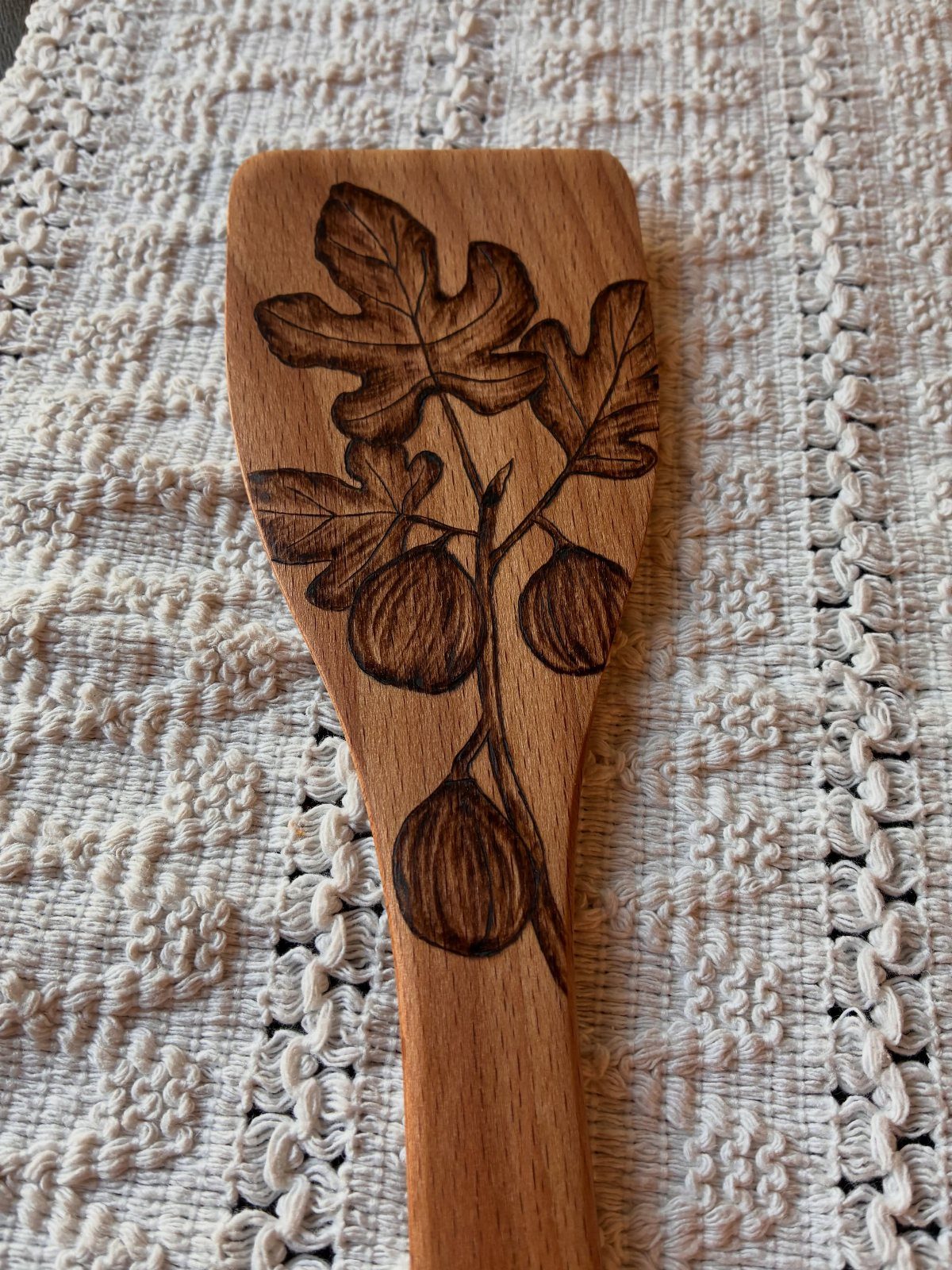 5 Homemade Christmas Gifts for Dad You Can Make 1 Wooden spoon with wood burned fig branch design on white lace background