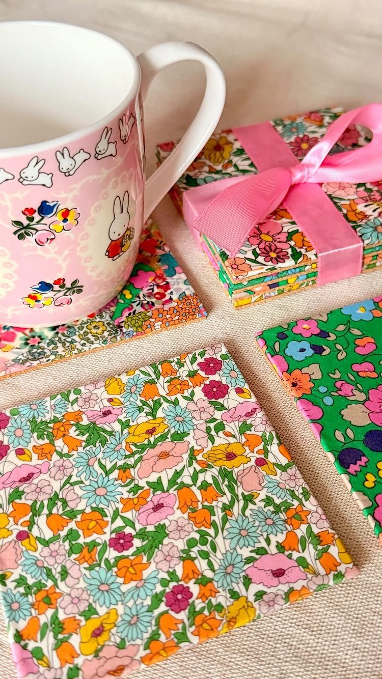 13 Homemade Gift Ideas for Coworkers They'll Use 11 Floral fabric coasters arranged on a table with a white decorative mug.